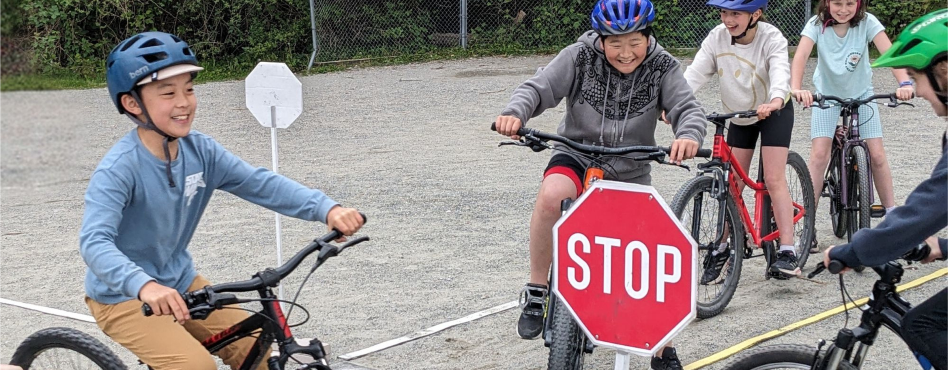 Students ride their bikes through a traffic garden on school grounds.