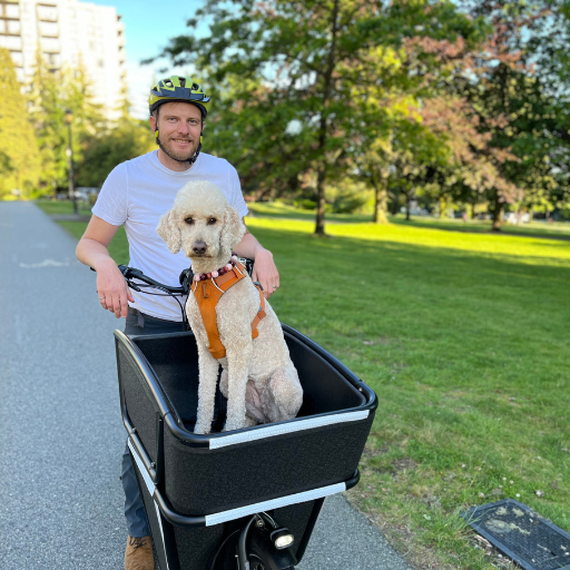 A photo of Luke Gillies with his dog in a cargo bike.