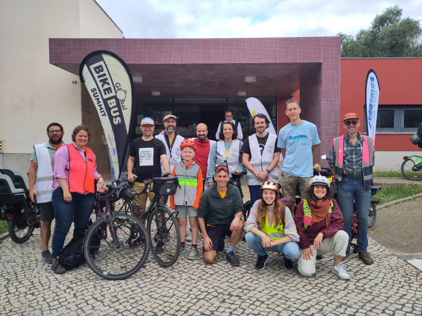 Global Bike Bus Summit. A group of people pos for a group photo.