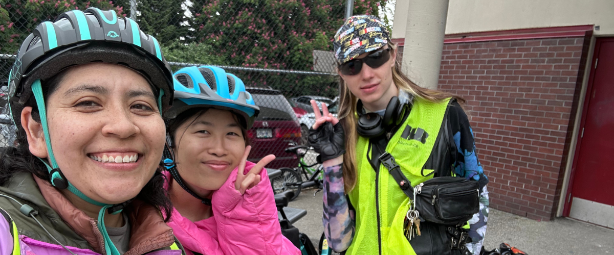 Three bike education instructors take a selfie together.
