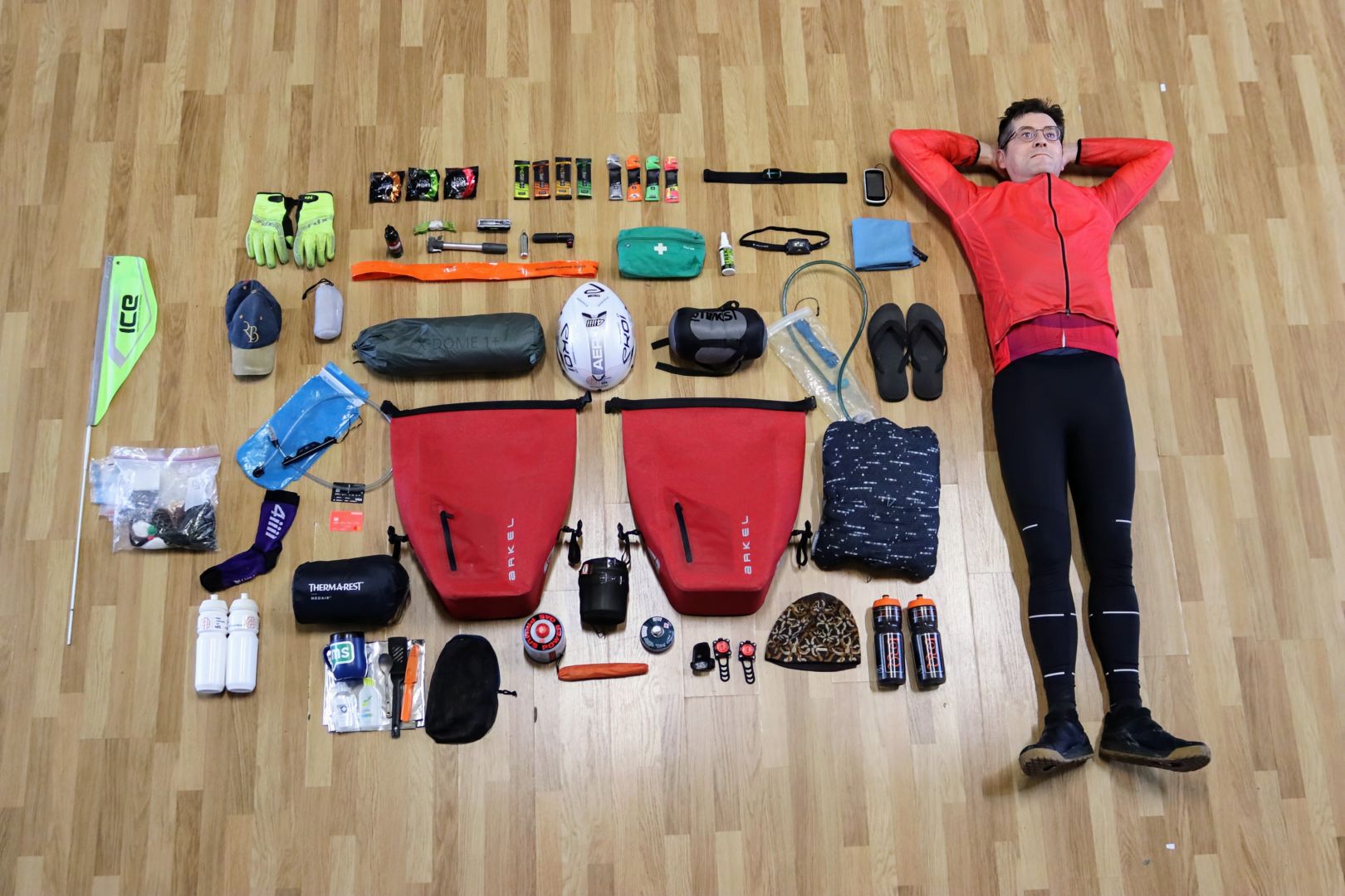 Dominic lies on the floor beside his cycling gear.