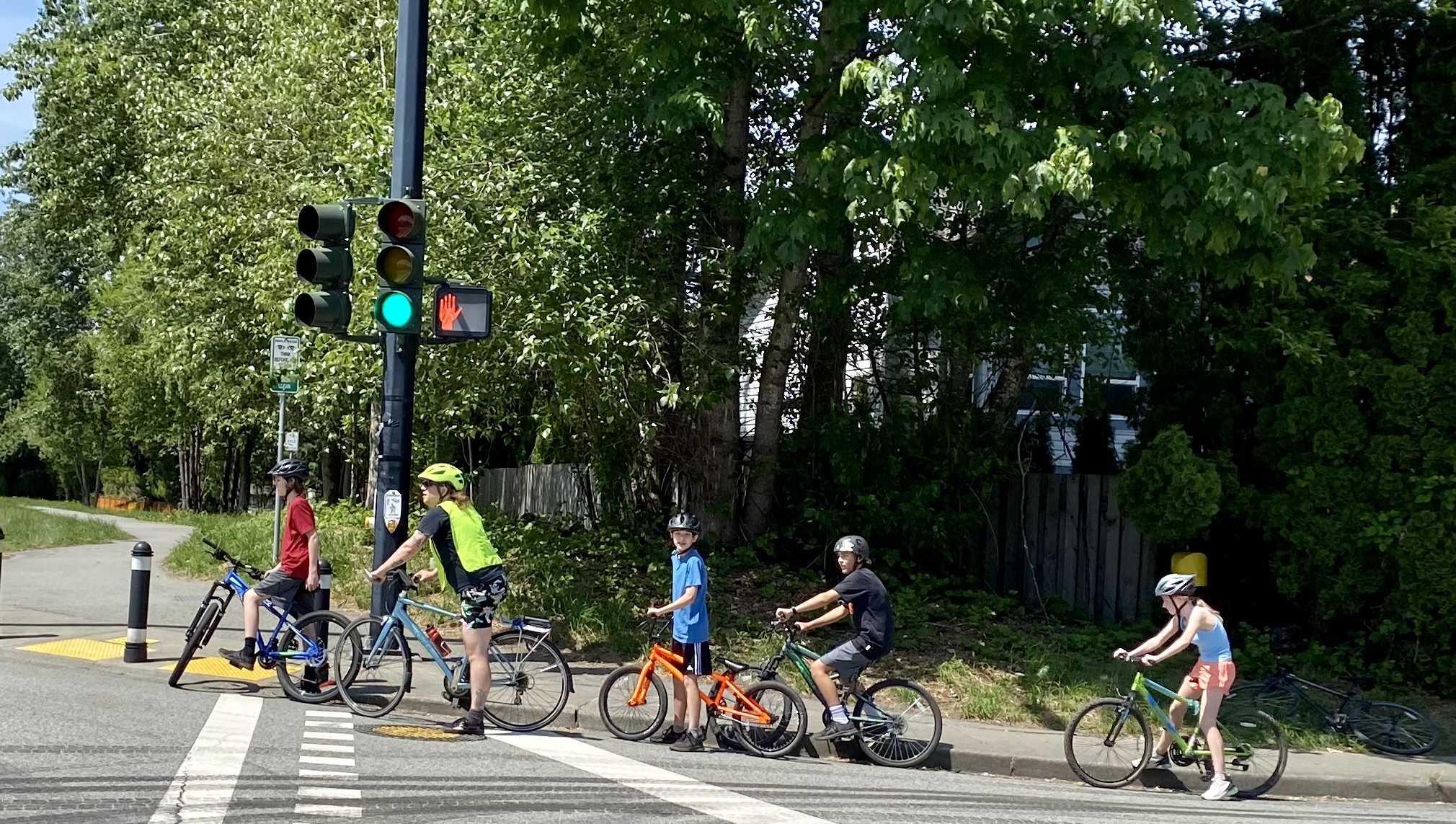 An instructor leads a road ride. Students follow on their bikes.