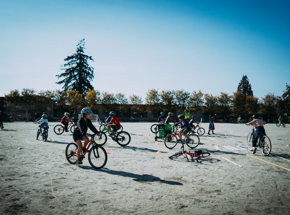 Students ride their bikes around the school grounds.