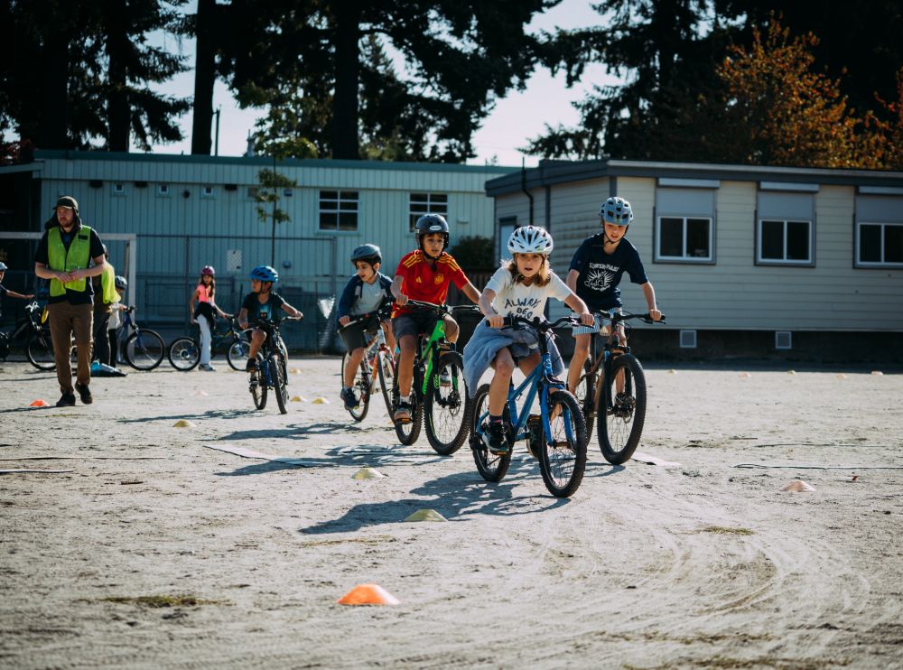 Students ride their bikes around school grounds.