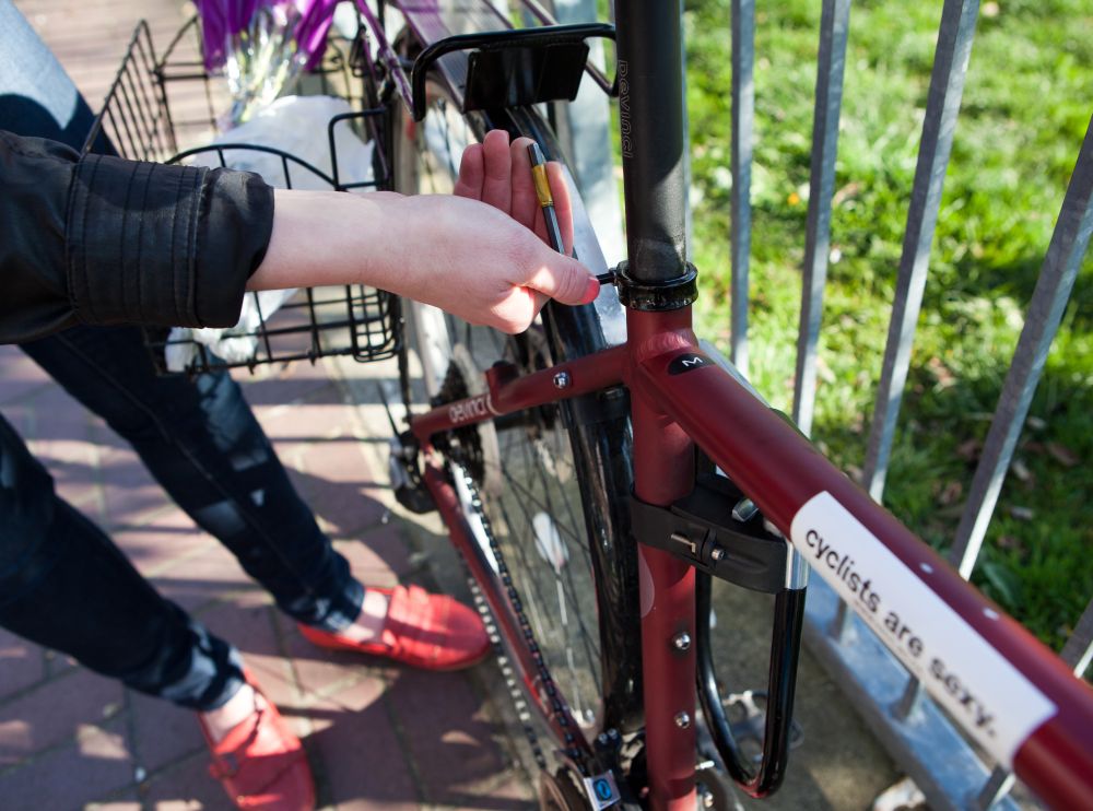 A cyclists adjusts the seat height of their bike.