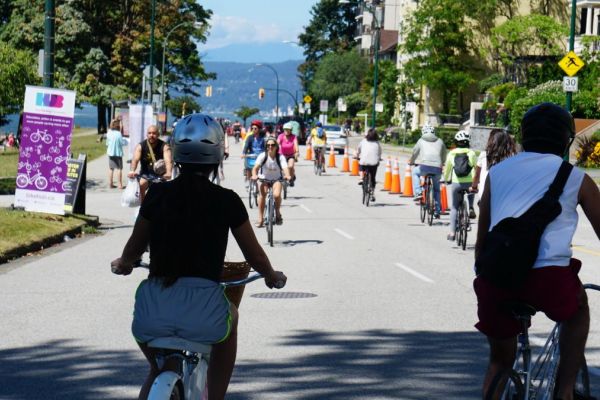 People ride bikes on Beach Ave in Vancouver.
