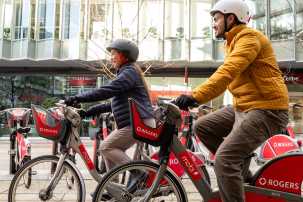 Two people ride Mobi by Rogers bikes.