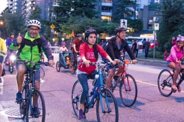A group of people ride bikes at dusk during Bike the Night.