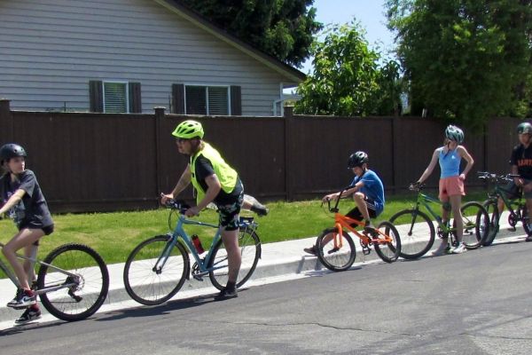 Students ride on the road together.
