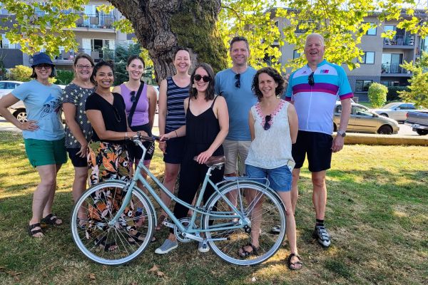 HUB staff posing with a bike in a park