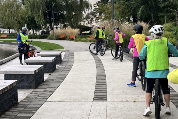Several people ride on a multi-use path.