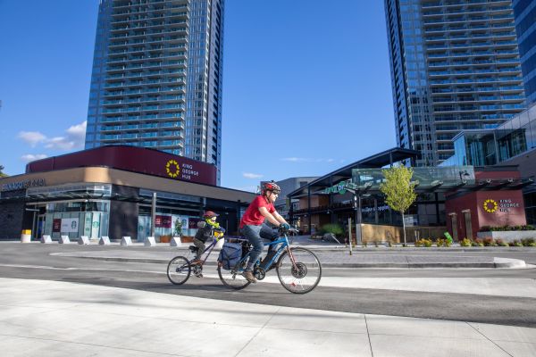 Tim Yzerman and one of his daughters cycle on a bike lane near Surrey's city centre.