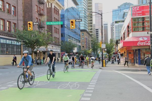 A photo of several cyclists riding a busy bike lane in Vancouver.