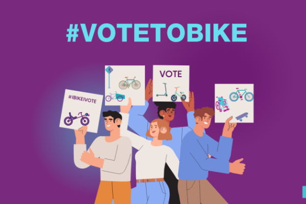 An illustration of four people holding signs with pictures of bikes and other active transportation mobility devices. Above the illustration, text reads: "#VoteToBike".