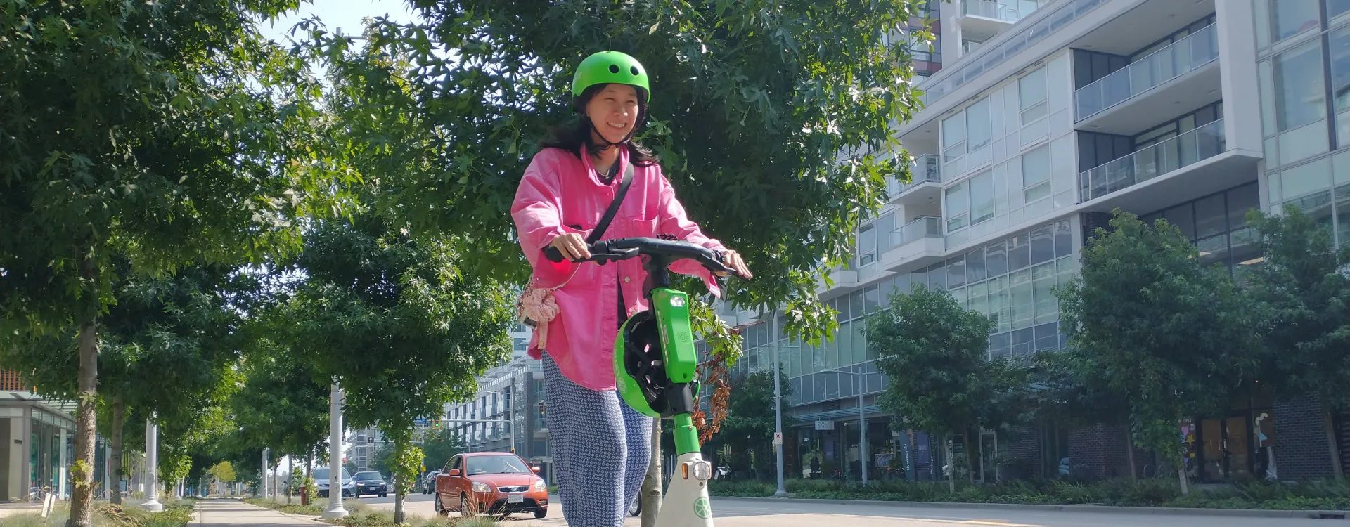 A woman rides an e-scooter.