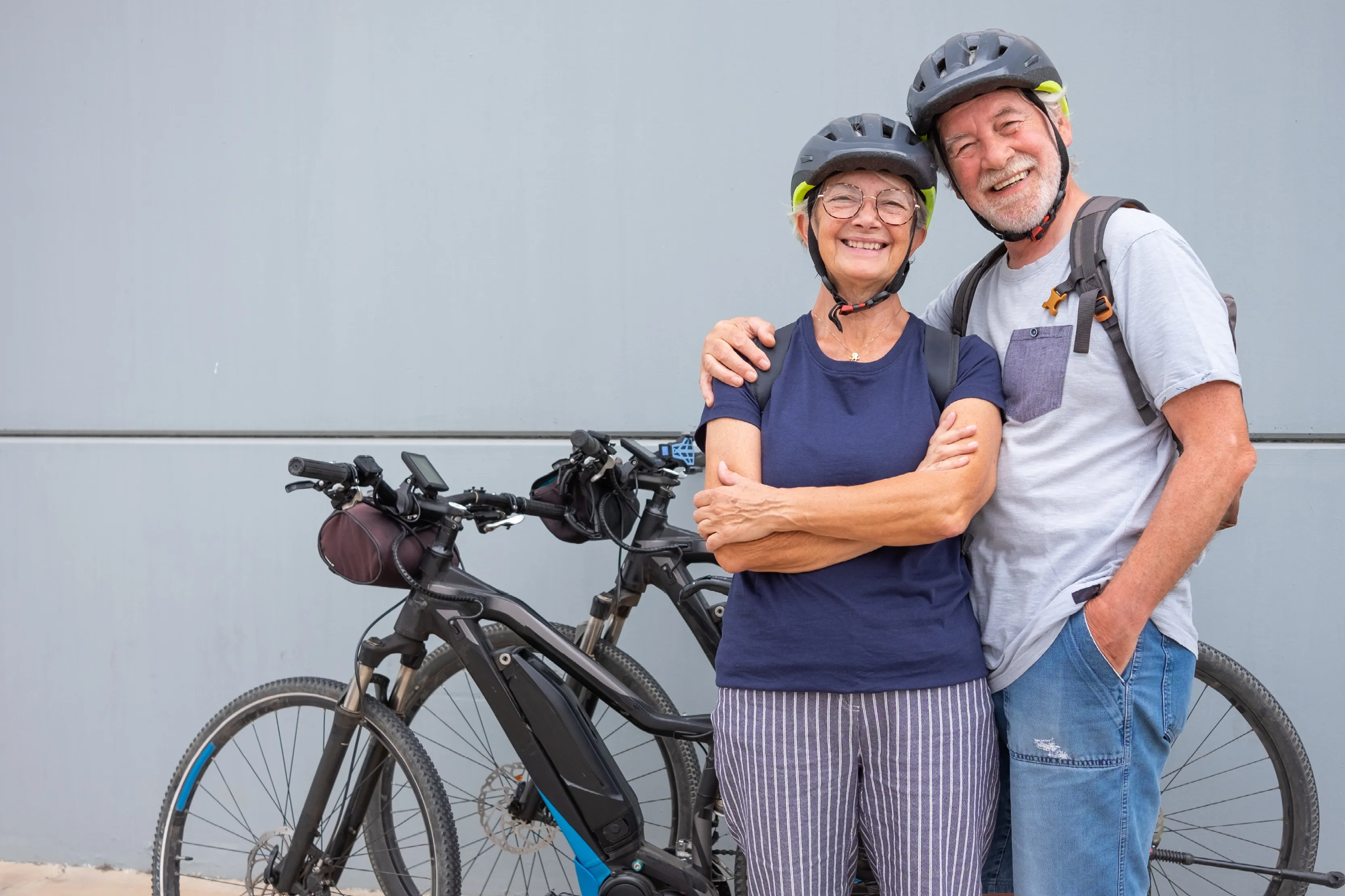 An adult couple with their e-bikes
