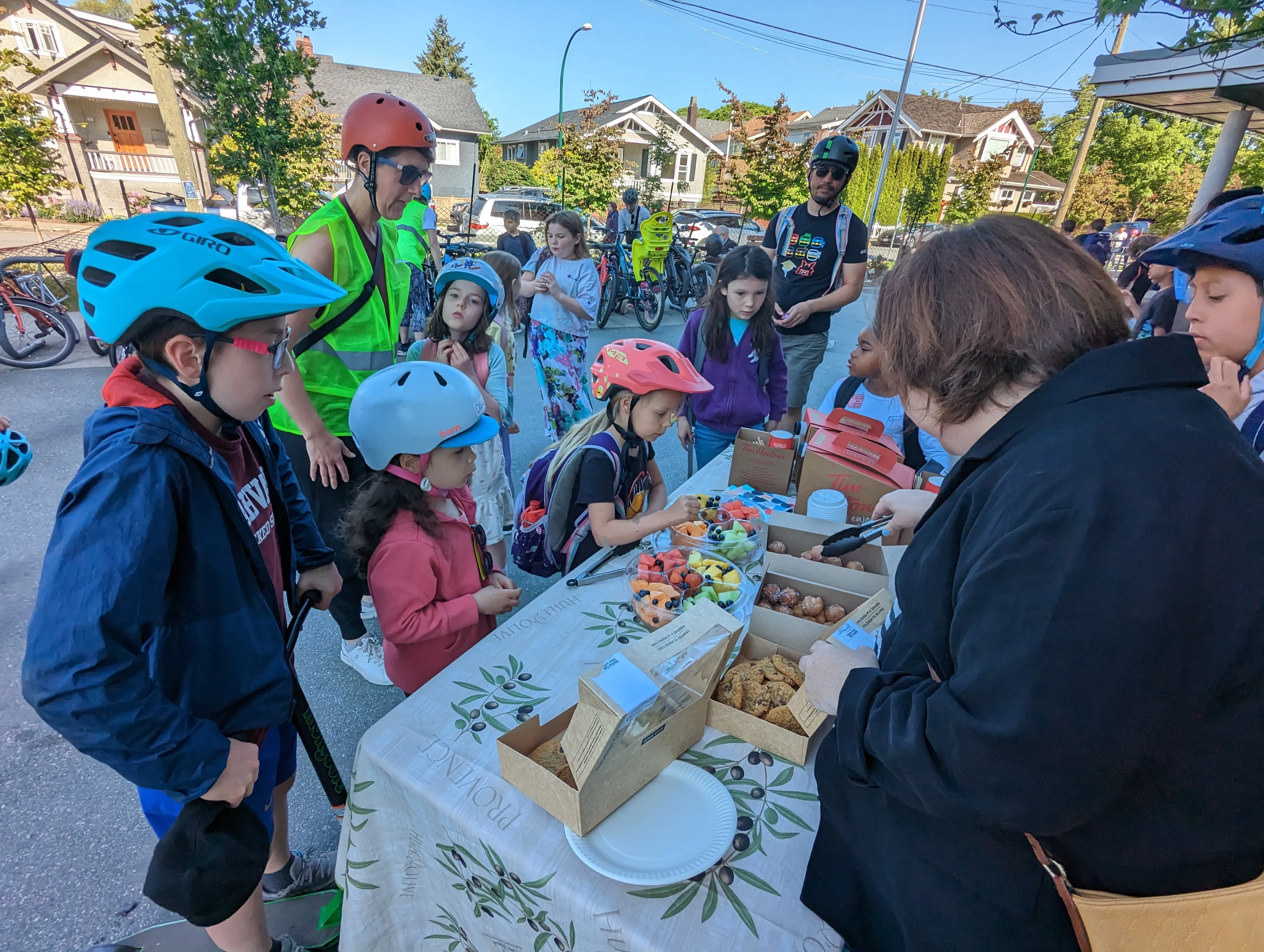 Several students gather around a Bike to School Week table.