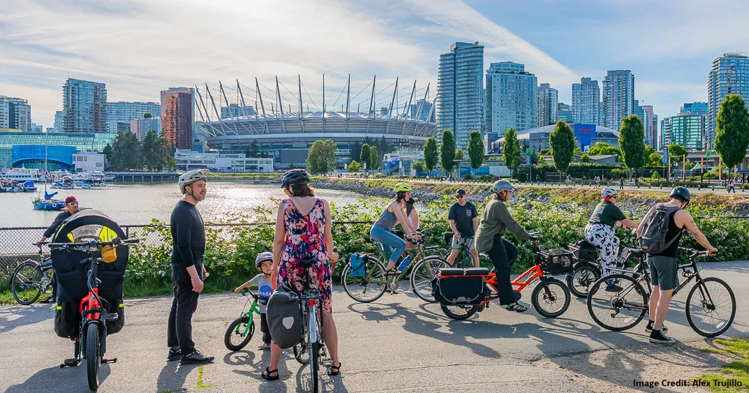 People on bikes on the Vancouver Seawall by BC Place. Image Credit: Alex Trujillo 