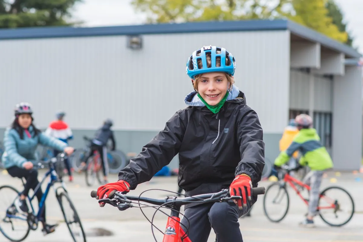 A boy rides his bike on school grounds.