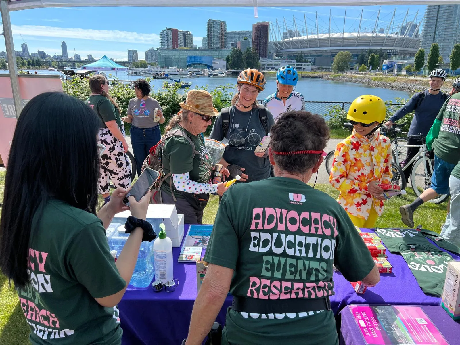 A bunch of people gather around an events table.