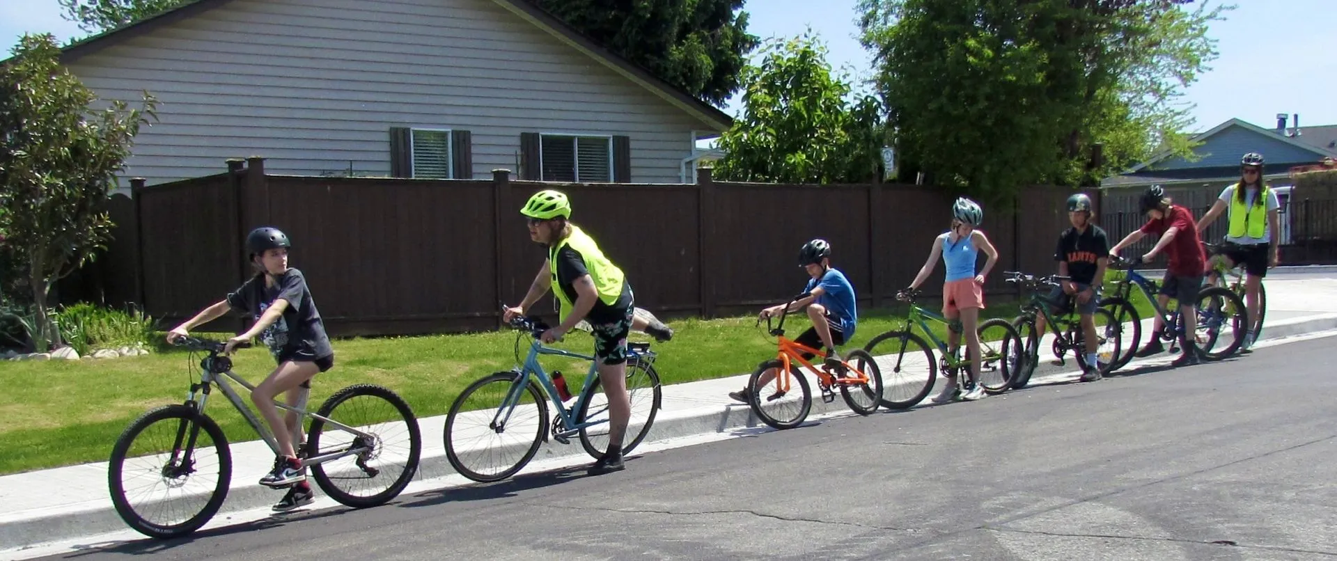 Students ride on the road together.