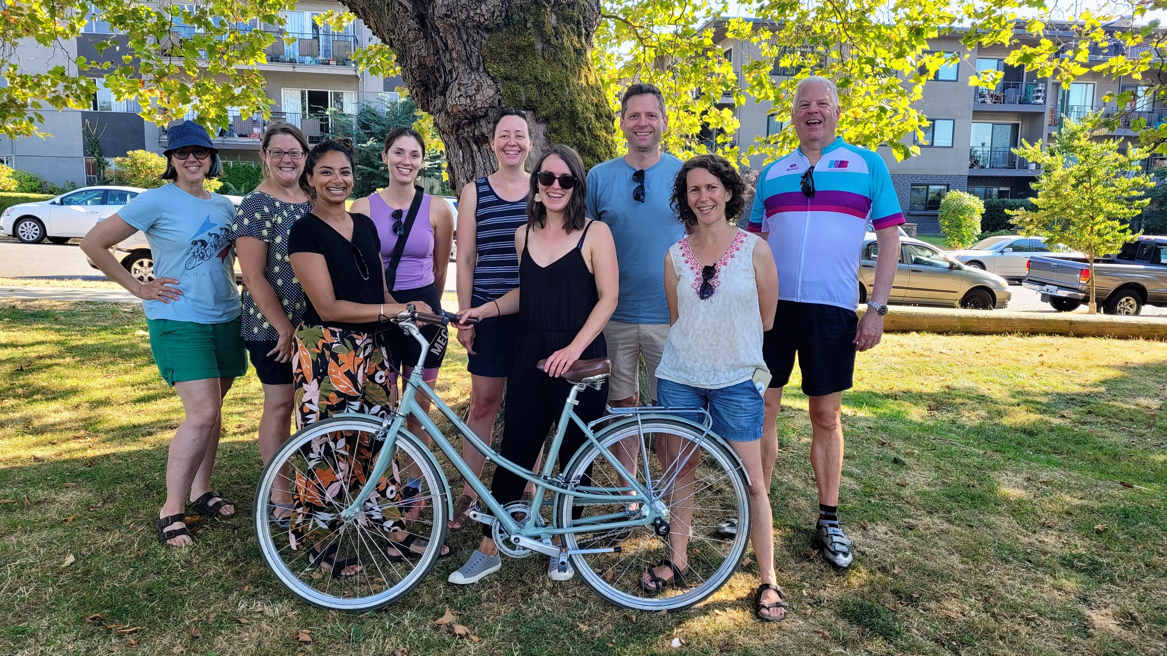 HUB staff posing with a bike in a park